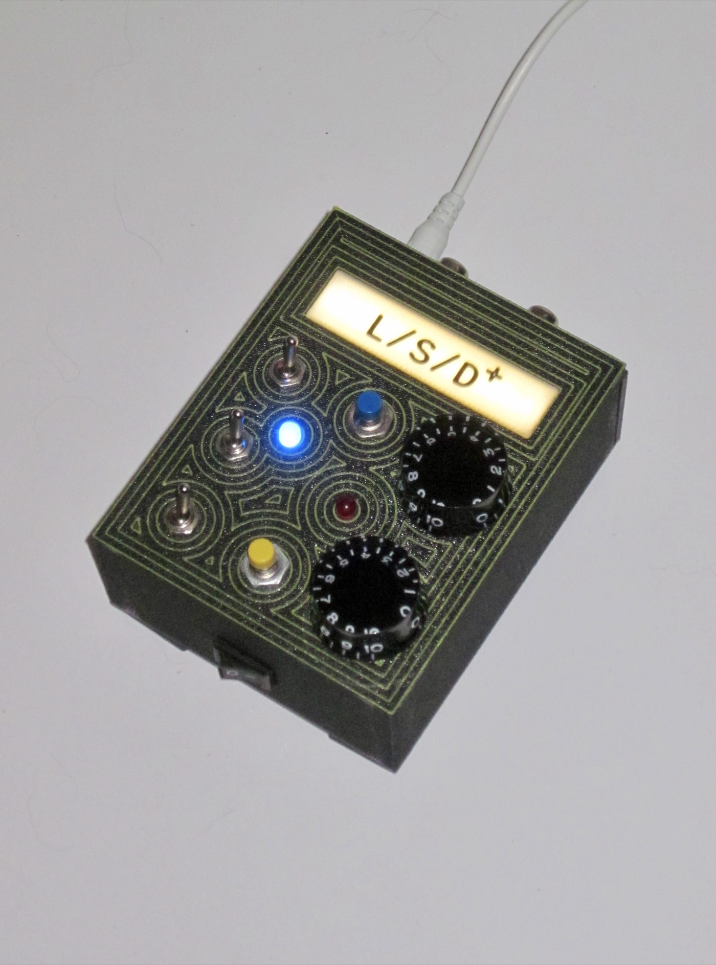 Concentric-pattern unit with numbered dial knobs, warm white backlight, straight on