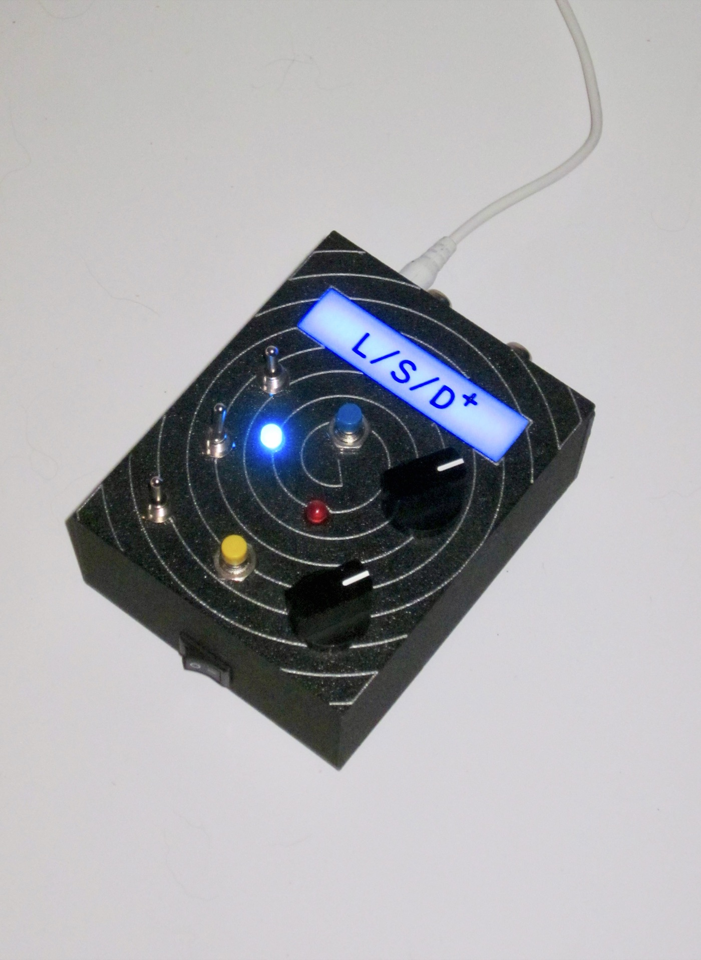 Spiral-pattern unit, blue backlight, angle showing the side power rocker
